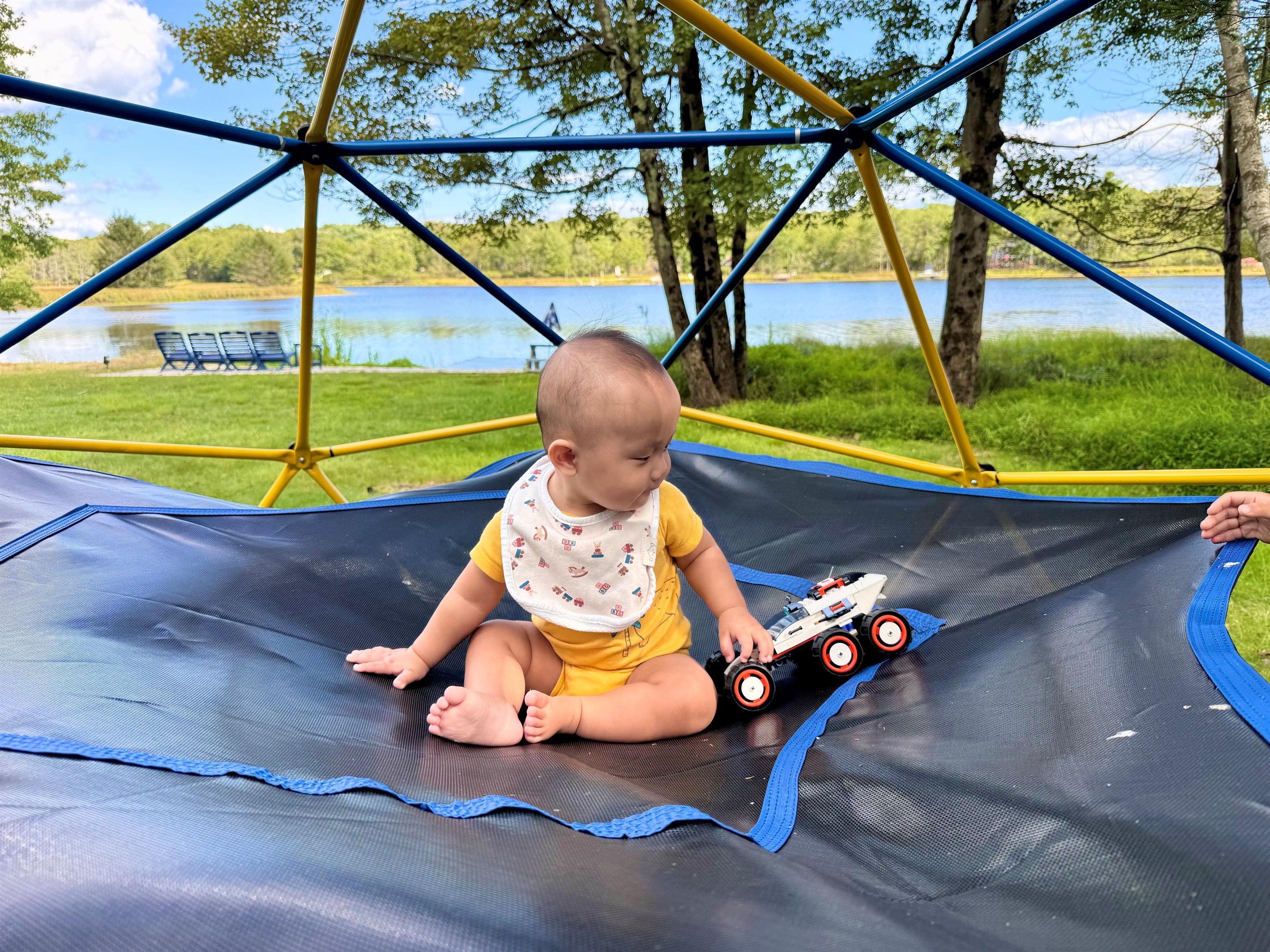 Little feet exploring big adventures — joy on the climbing dome.