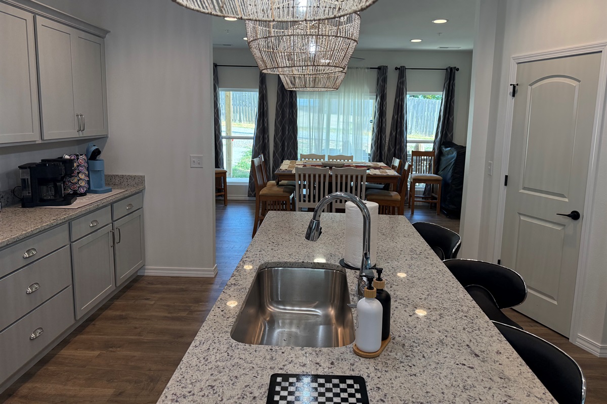 View for kitchen island into dining room area. Tons of glass windows add to open concept feel.