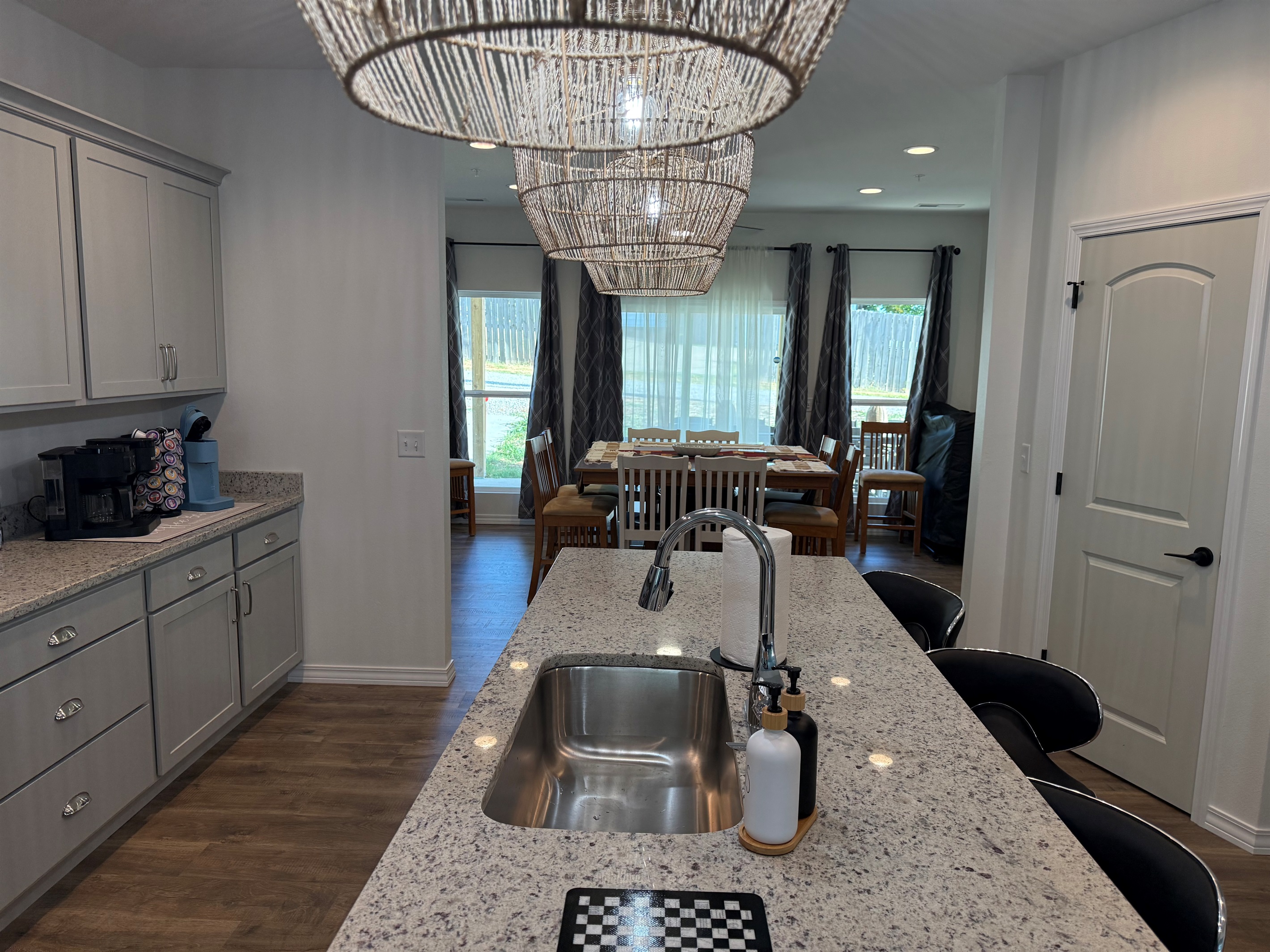 View for kitchen island into dining room area. Tons of glass windows add to open concept feel.