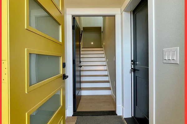 Walk in through a bold front door and straight up the staircase — first impressions start before you've even set your bags down.