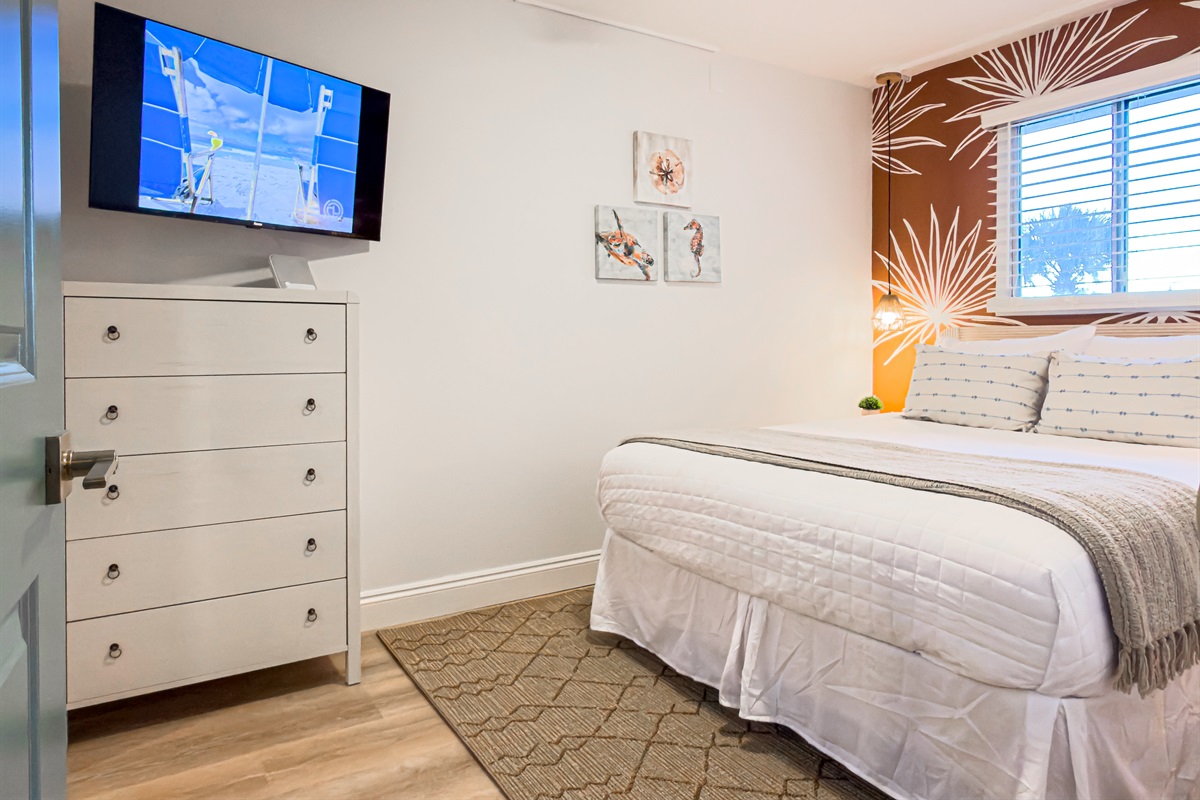 Queen guest bedroom where the quiet ceiling fan keeps the room cool on warm nights.
