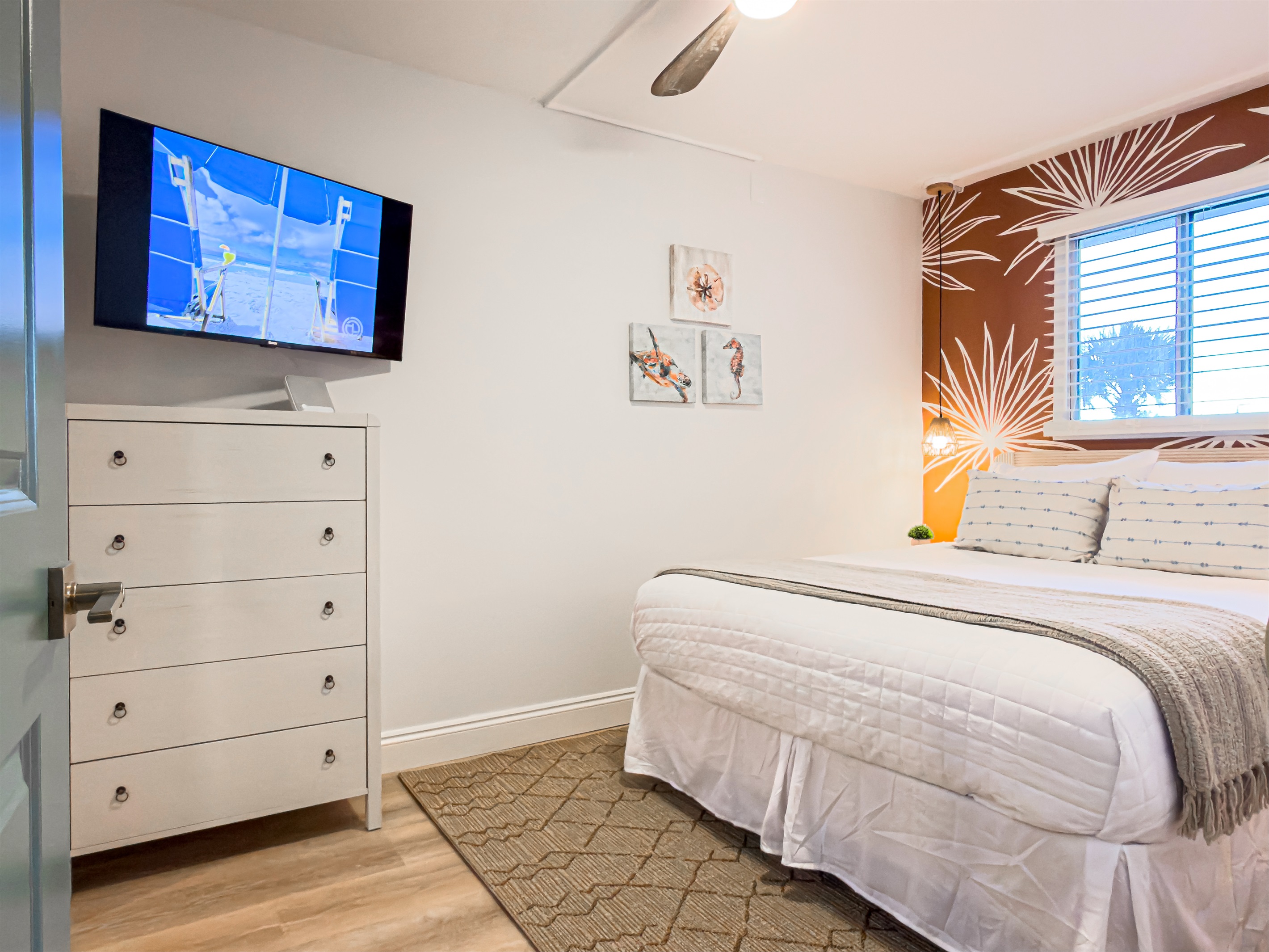 Queen guest bedroom where the quiet ceiling fan keeps the room cool on warm nights.
