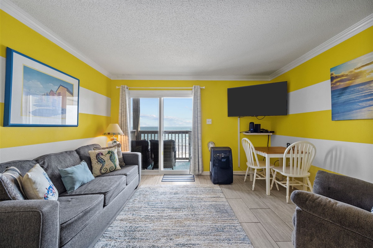 Open living space designed for relaxing after a beach day, with ocean views just beyond the sliding doors