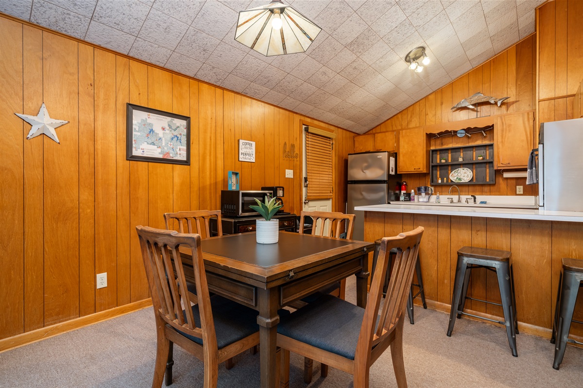 The mid-century table extends to seat 6 and the bar seats 3.