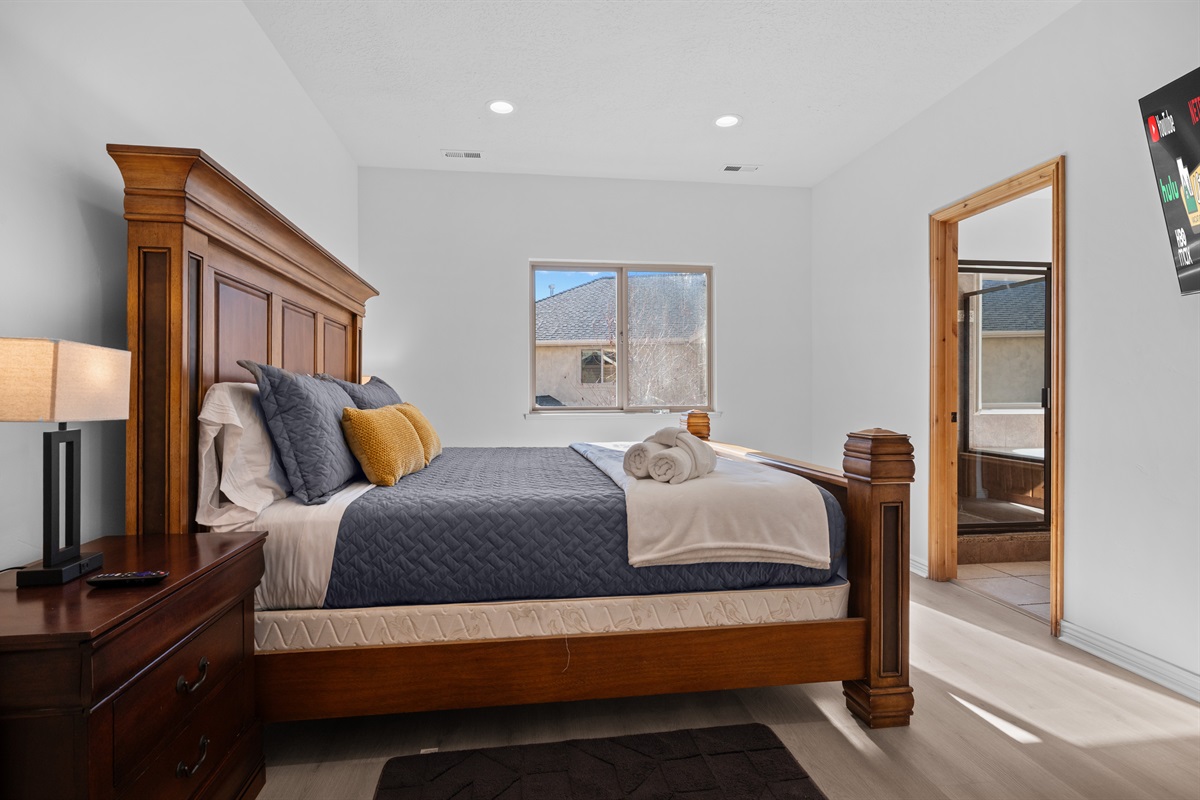 The primary bedroom suite boasts a luxurious king-sized bed and ample storage space.