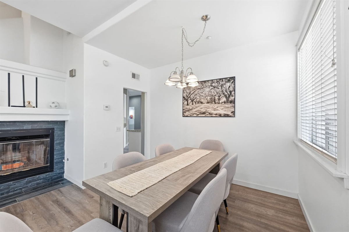 Large dining table with seating for the full group. Open-concept layout, natural light, and easy flow to the fully equipped kitchen. Coastal family rental in Oxnard CA.