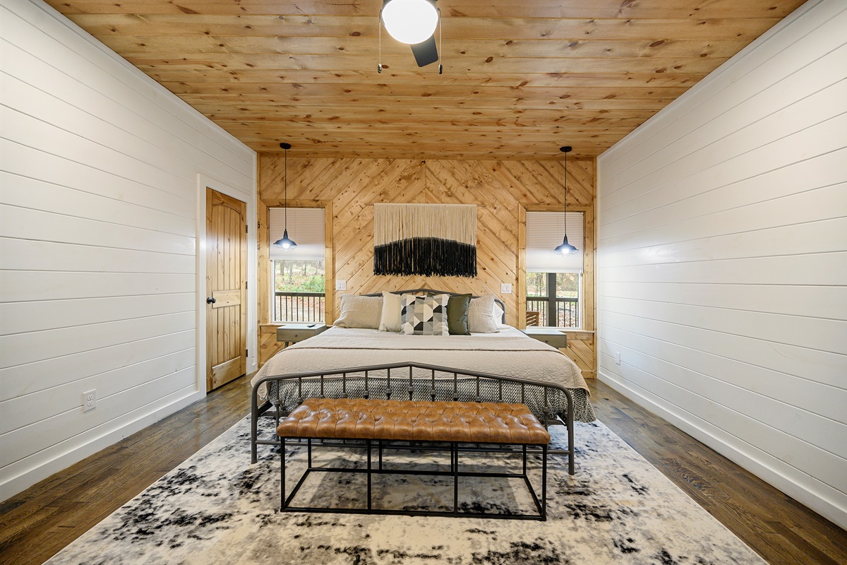 King bedroom comfort with a private ensuite bathroom waiting just beyond the door. 
Soft bedding, warm wood tones, and the kind of peaceful atmosphere that makes sleeping in feel like part of the vacation.