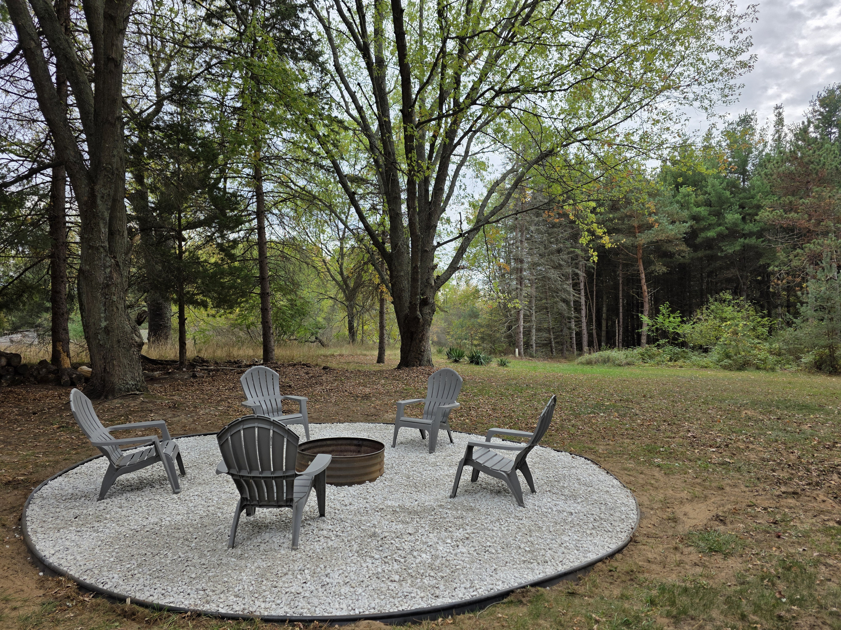 Backyard firepit with Adiondack chairs