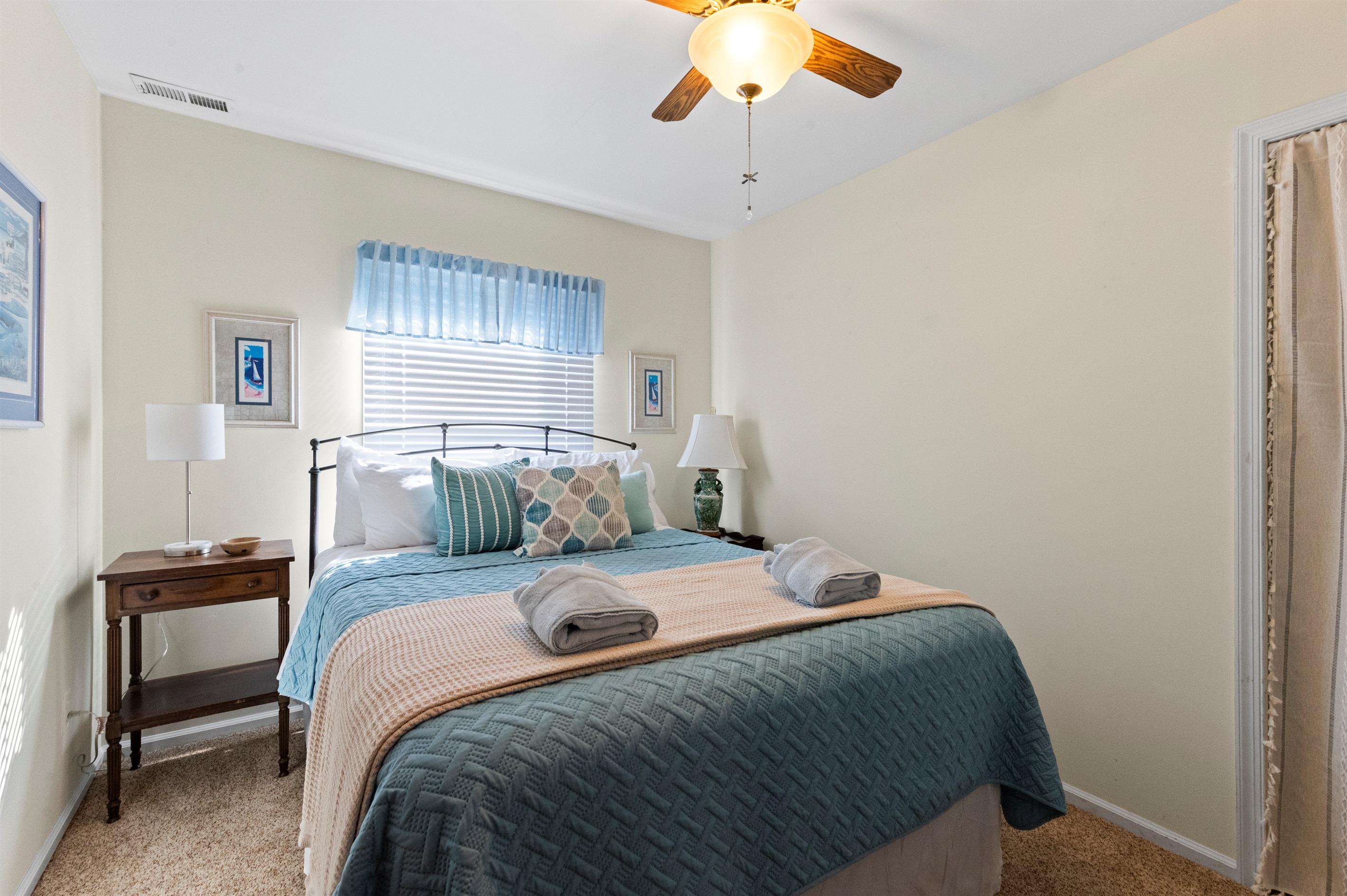 Bedroom Queen: Bright and airy retreat with plush bedding and artful decor awaits your dreams!