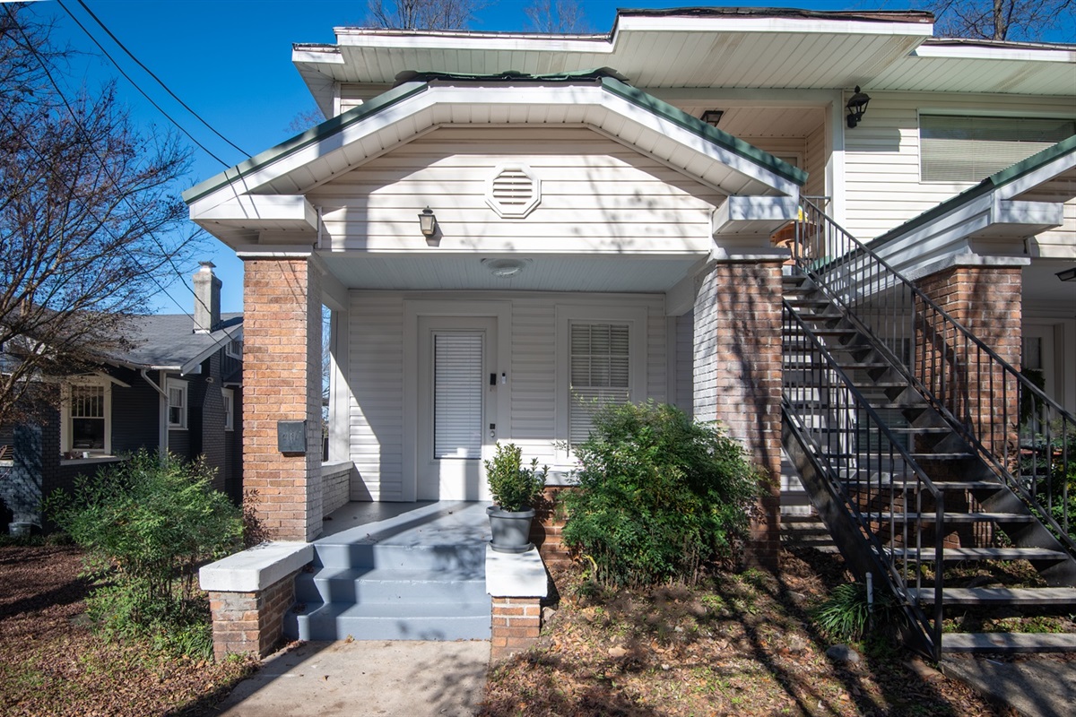 Classic facade of the historic triplex with a welcoming entrance.