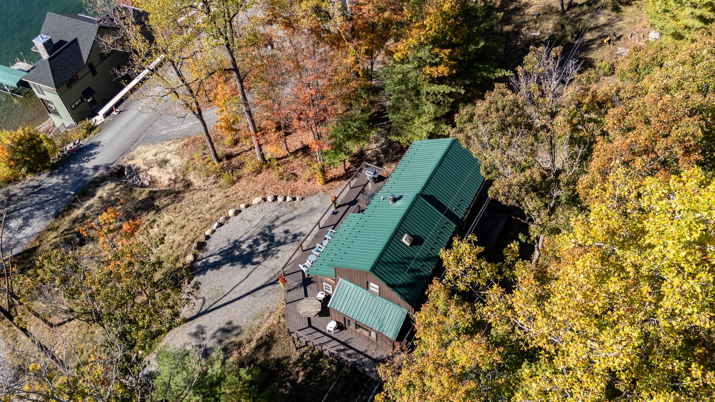 Aerial view of the cabin tucked into the trees above Keuka Lake — your hillside escape.