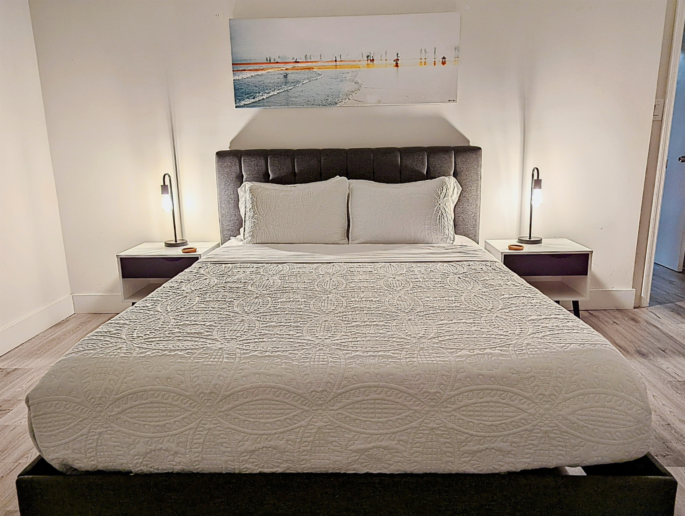 Welcome to your primary bedroom with queen bed, overlooking the turquoise pool.