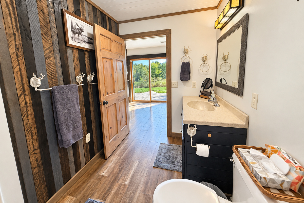 Looking out from the bathroom, you’ll see the patio doors and the path toward the stairs. Head up to the third level, where you’ll find three additional bedrooms and a full bathroom.