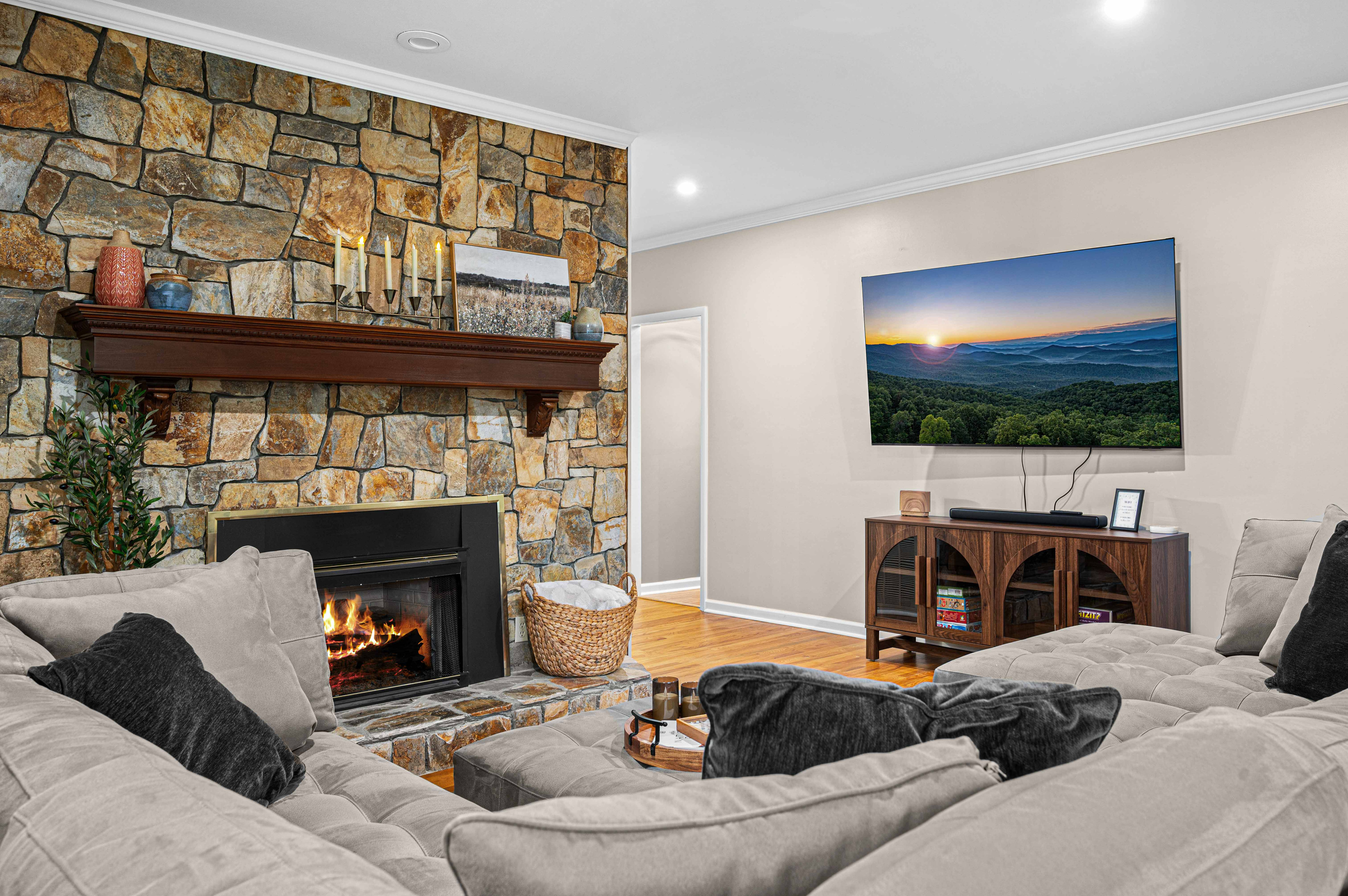 Living Room: Inviting stone fireplace and sweeping mountain views await your relaxation!