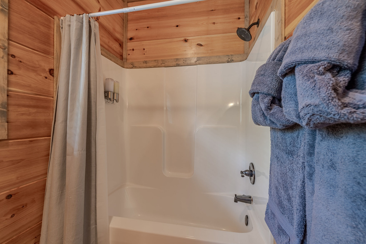 A second view of The Cartographer’s Suite ensuite bathroom with shower and guest-ready amenities.
