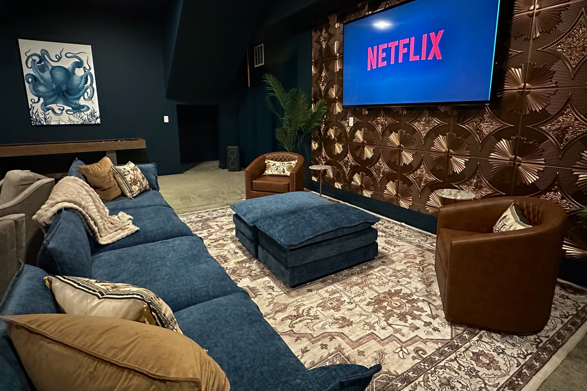 Drop into the leather swivel chairs and dim the lights — the 85-inch screen takes over for movie night in the speakeasy.