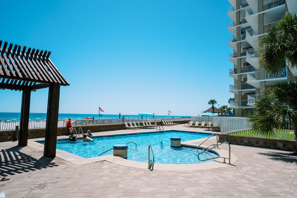Includes loungers and umbrellas - adjacent to grilling area and outdoor tables.
