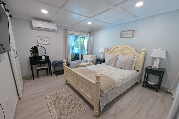 Dedicated makeup vanity table and seating area inside the queen guest bedroom at Villa Coral.
