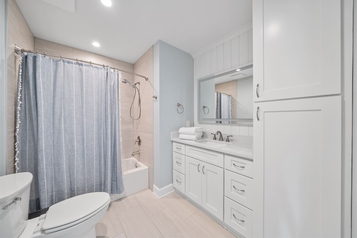 Full bathroom with a shower/tub combo in Unit A. 
