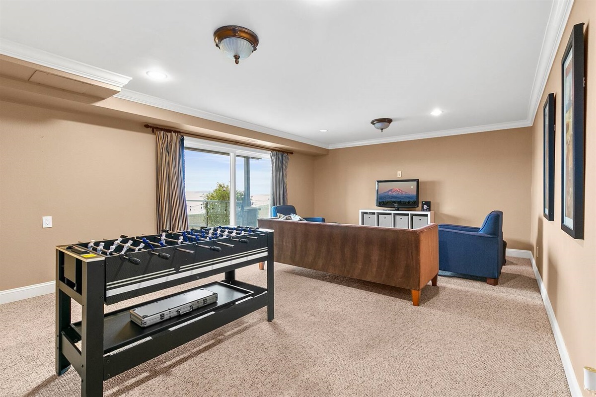 Lower level you will find a secondary living space/game room with patio terrace access. 