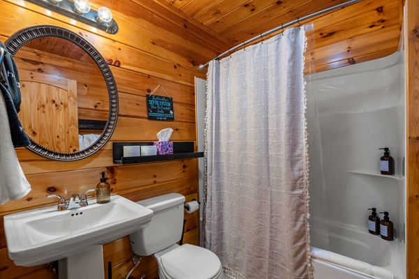 Full bathroom downstairs with tub