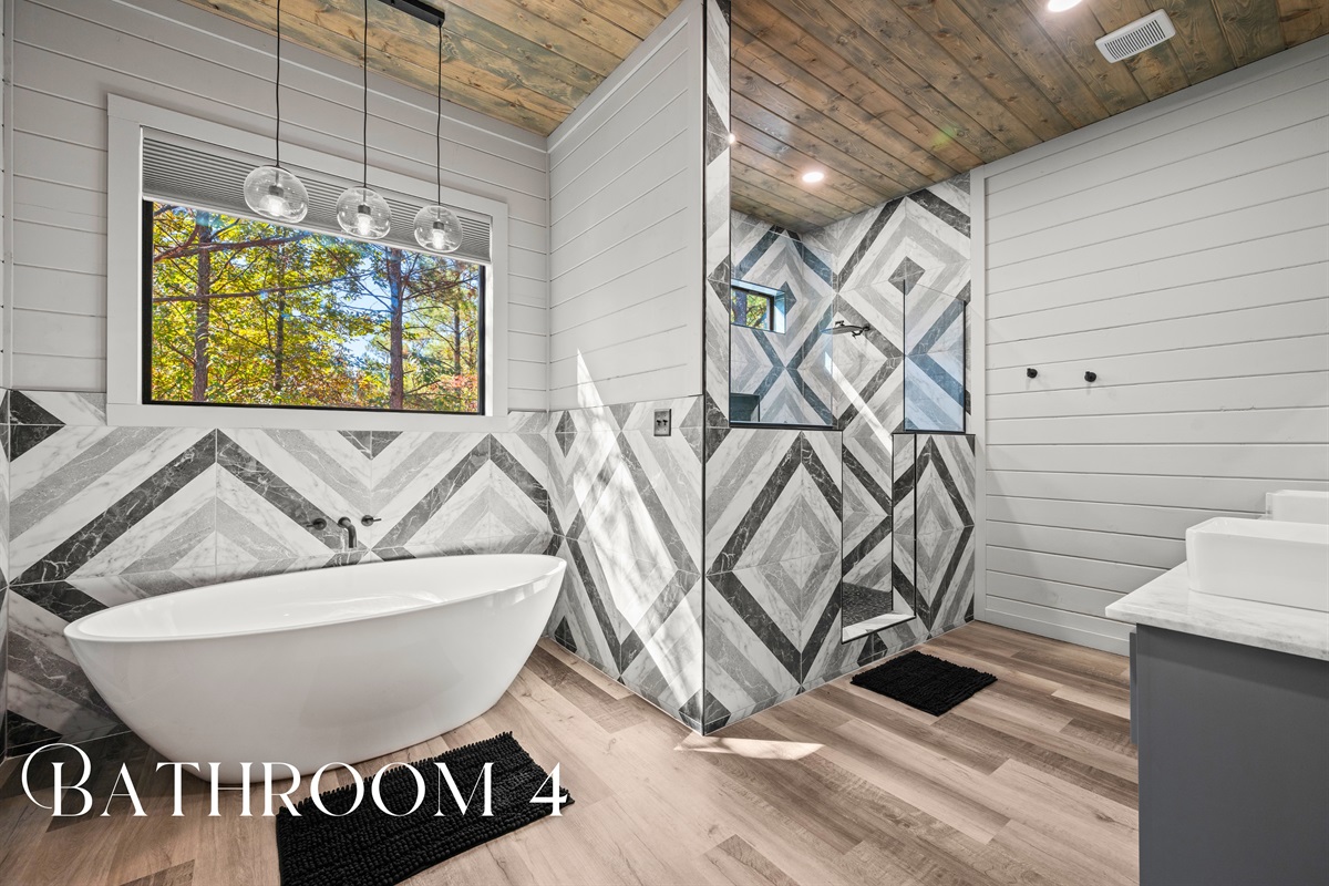 Unique tilework and a freestanding tub turn this bathroom into a spa-like sanctuary that feels fresh and luxurious.