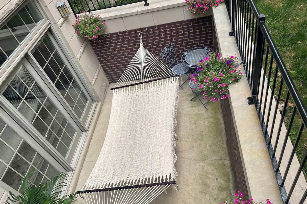 Relaxing outdoor patio with hammock for peaceful afternoon break.