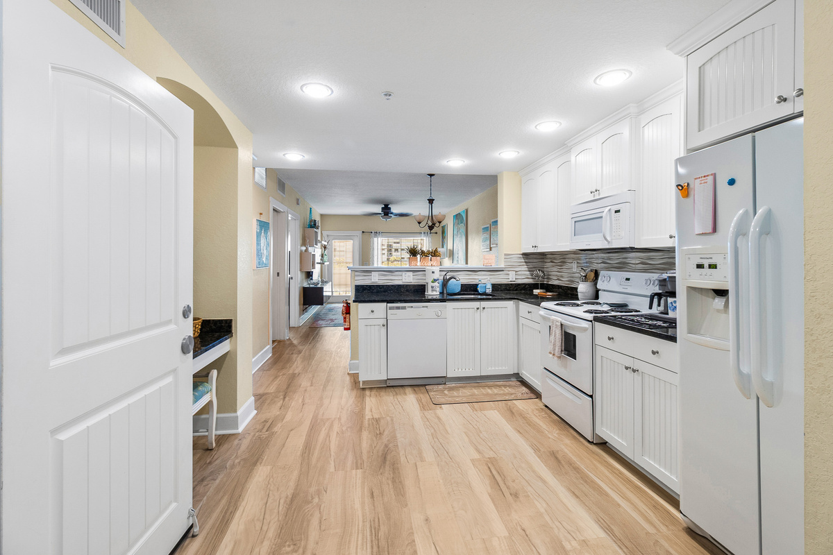 Kitchen, fully stocked with cooking/eating/drinking utensils.