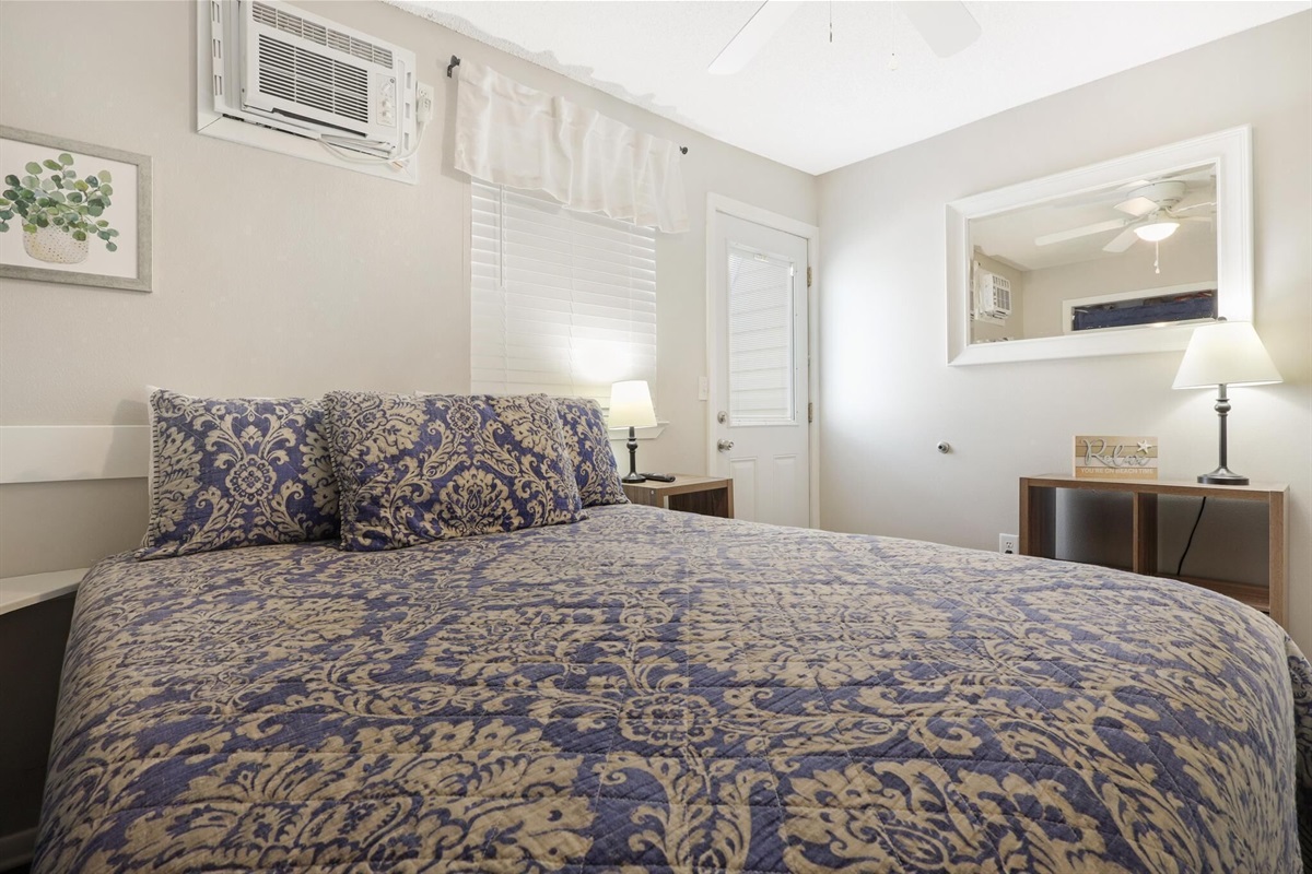 Bedroom - The spacious bedroom features Queen bedding, is tastefully furnished, and offers access to the balcony.