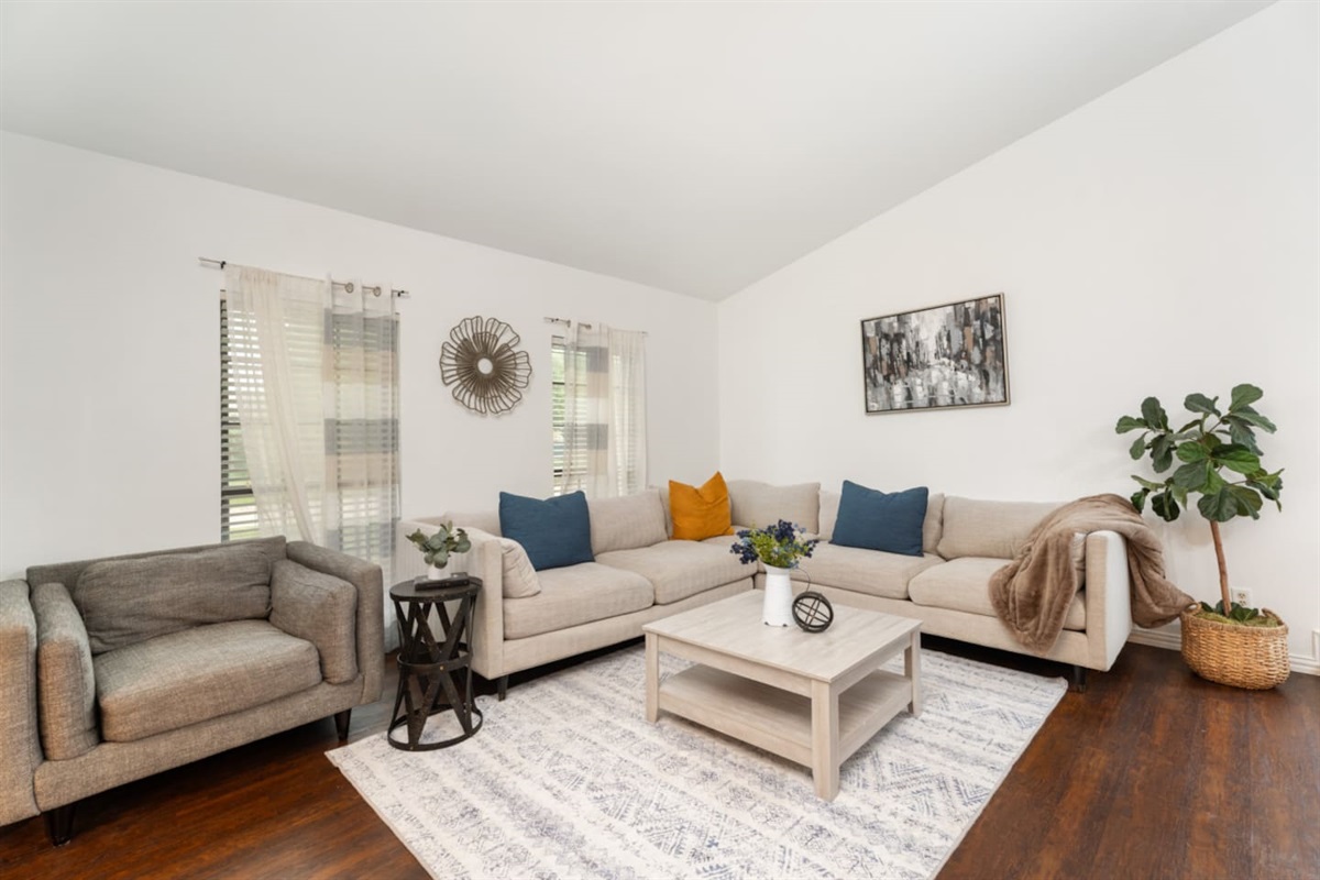 Bright and airy living room with sectional and natural light.