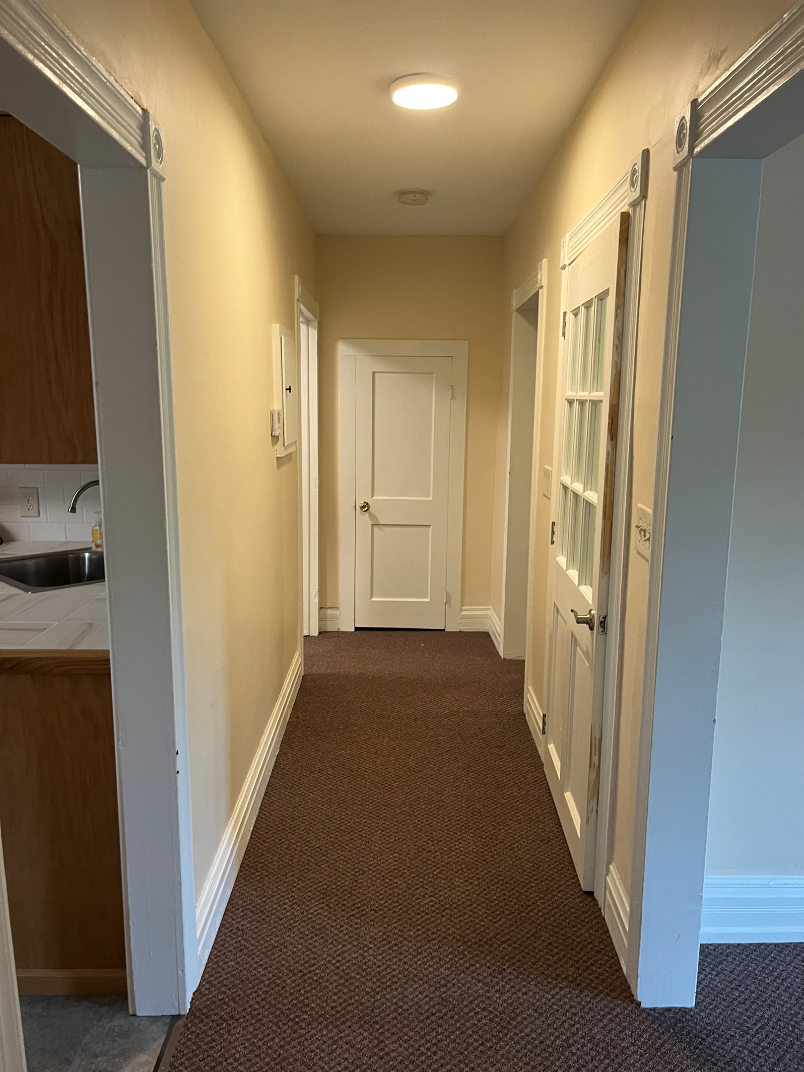Kitchen on left, living room on right, bathroom and Queen 2 at the end of the hall