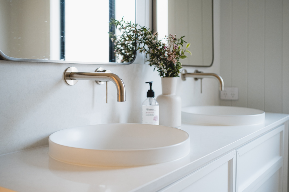 Enjoy the convenience of double sinks, perfect for getting ready together in this bright and beautifully designed bathroom.