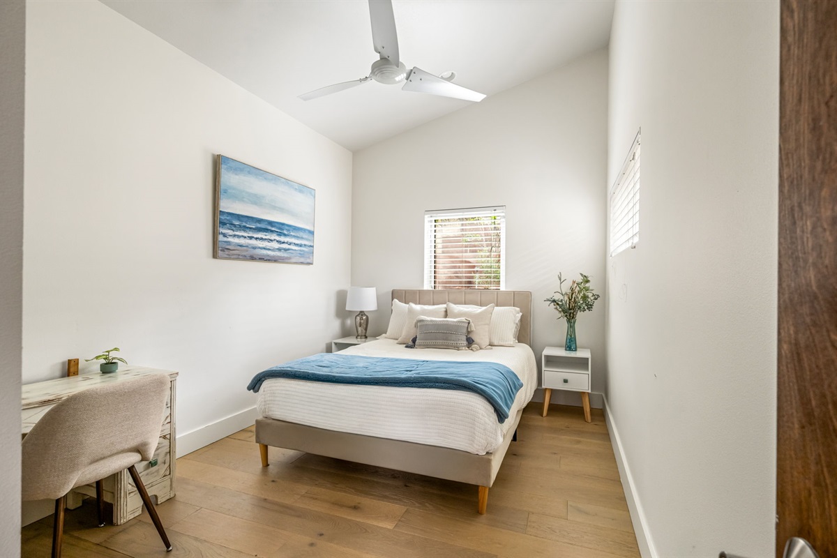 Quiet guest bedroom with a comfortable bed and ceiling fan
