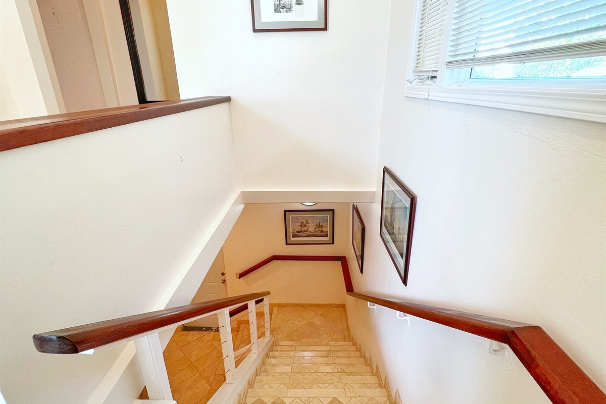 The interior staircase that brings you down to two king bedrooms that share a bathroom.