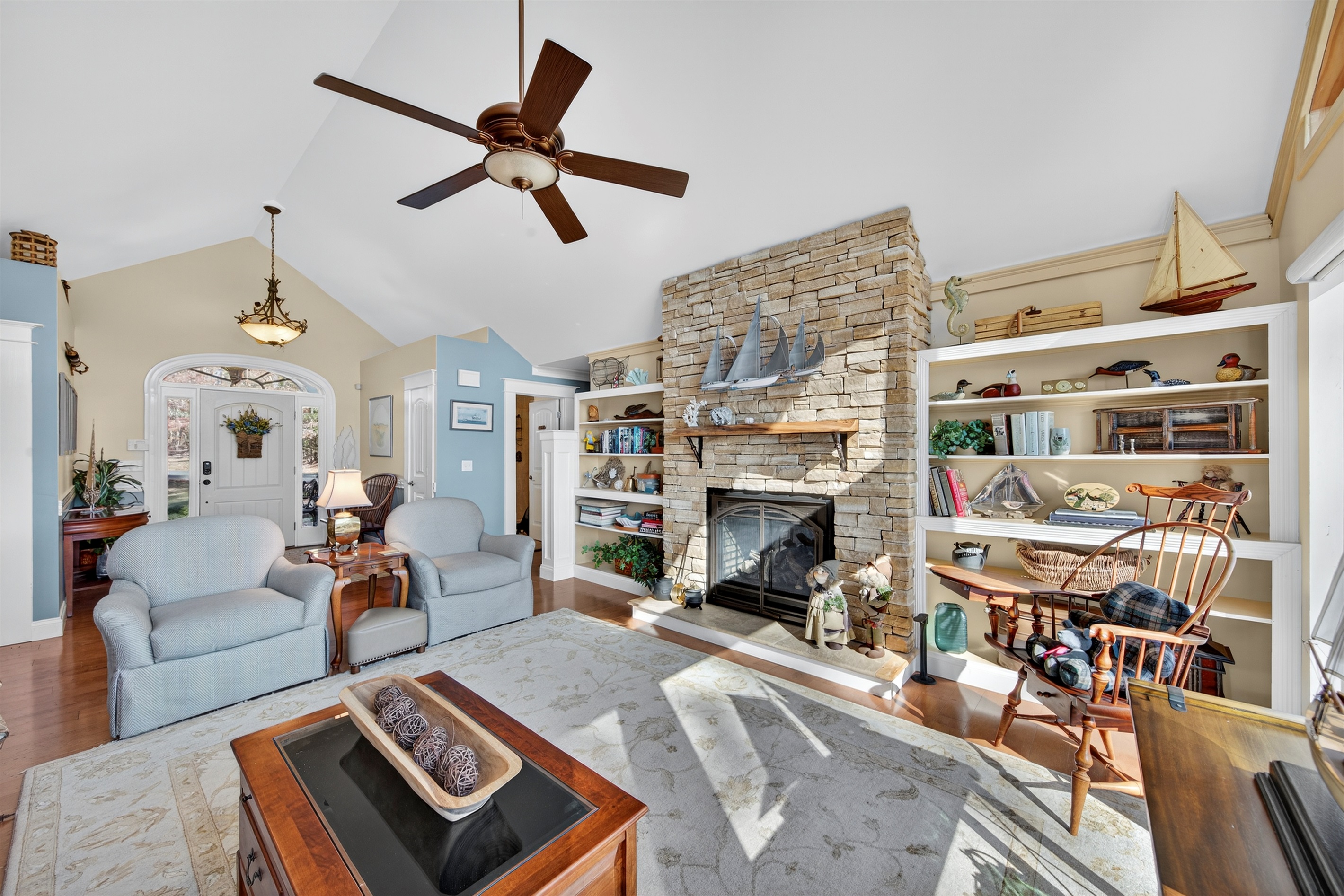 Cozy up by the stone fireplace while enjoying uninterrupted views of Lake Anna.