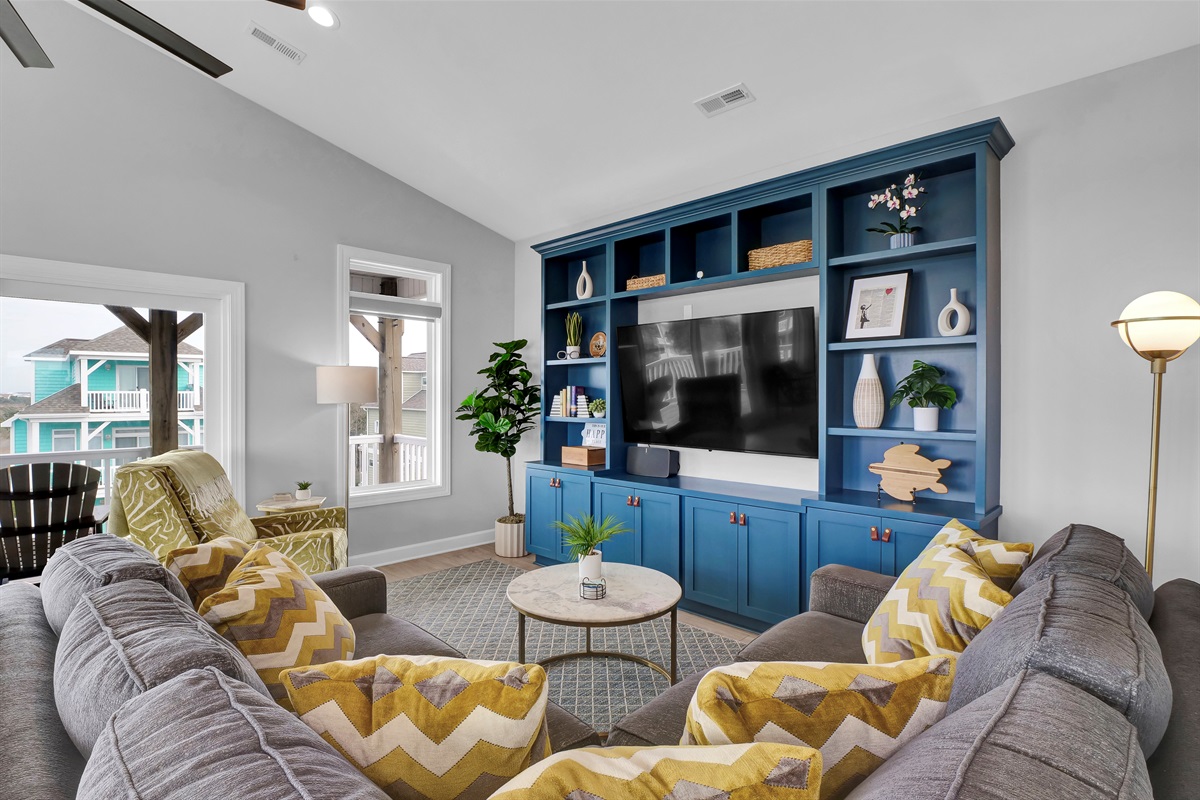 Relax in this bright coastal living room with Smart TV entertainment and modern furnishings
