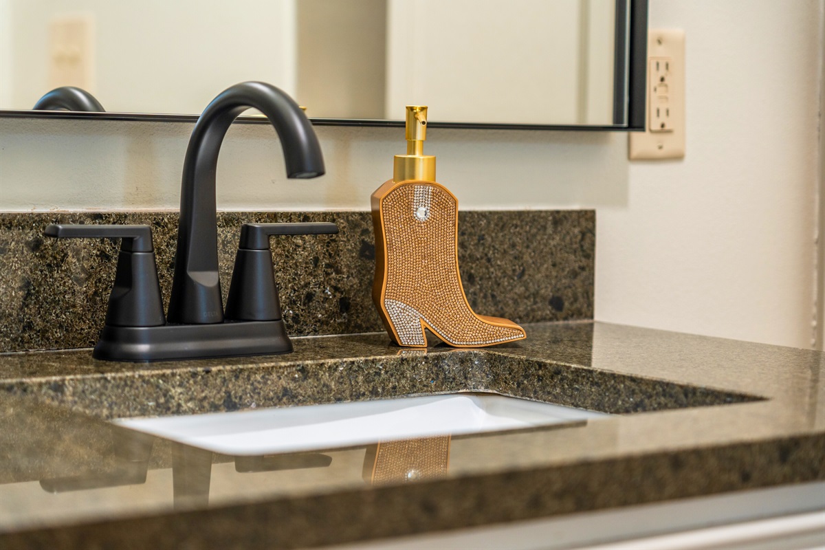 A close-up of the stylish bathroom sink area, where thoughtful details like delightful soap and chic decor create a spa-like experience.