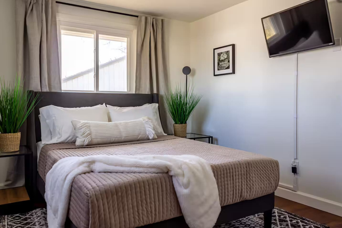 A plush throw at the foot of the bed invites you to curl up and stay awhile.