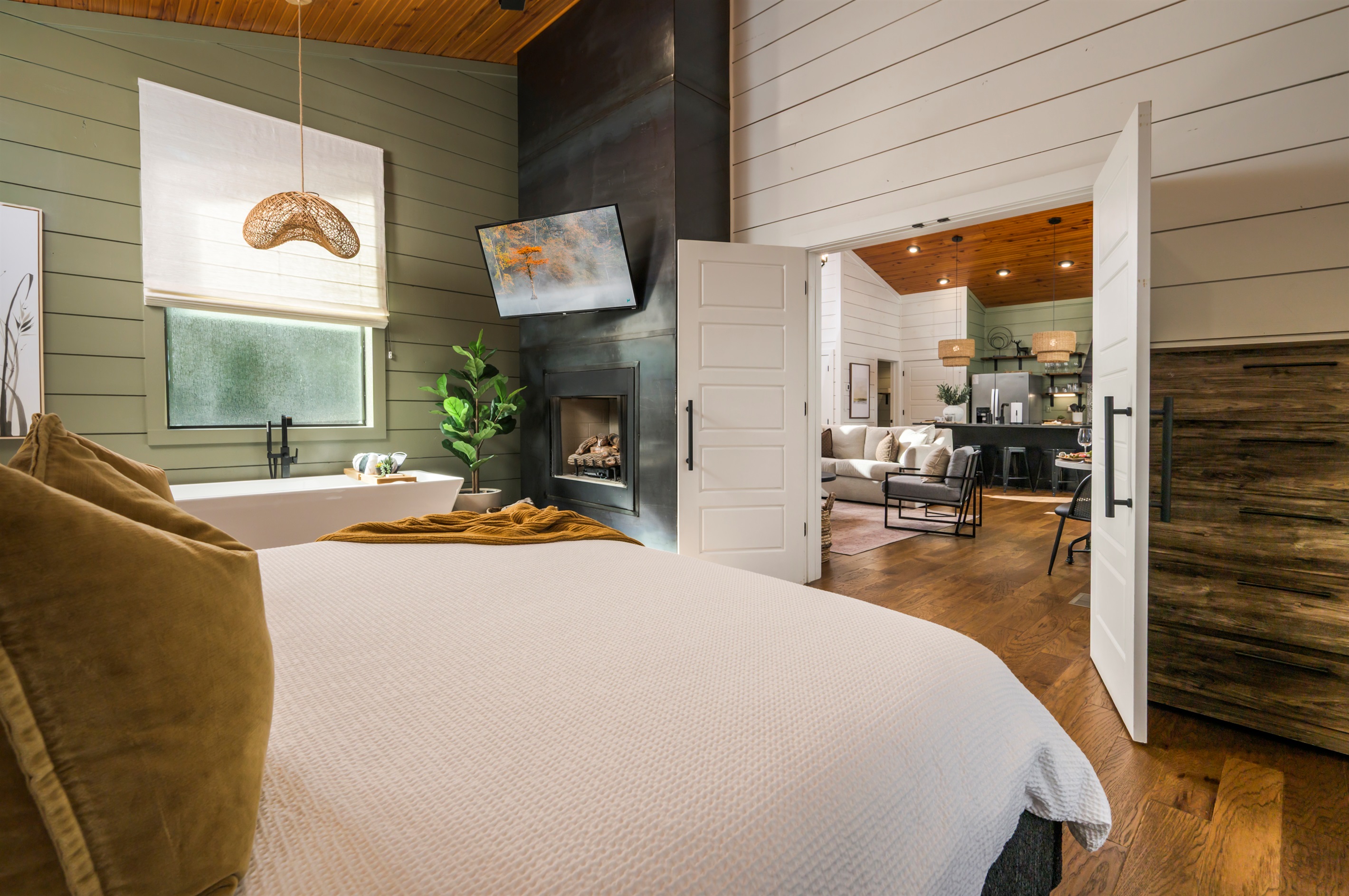 Your private retreat awaits—soft linens, warm wood tones, and seamless flow into the heart of the cabin. Come stay with us