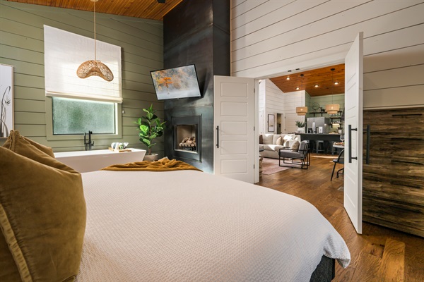 Your private retreat awaits—soft linens, warm wood tones, and seamless flow into the heart of the cabin. Come stay with us