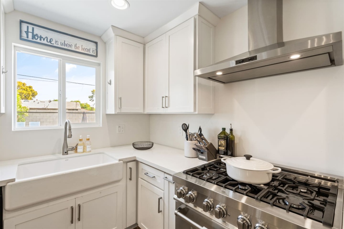 Gas range, farmhouse sink, and nearby counter space for easy meal prep during your stay.