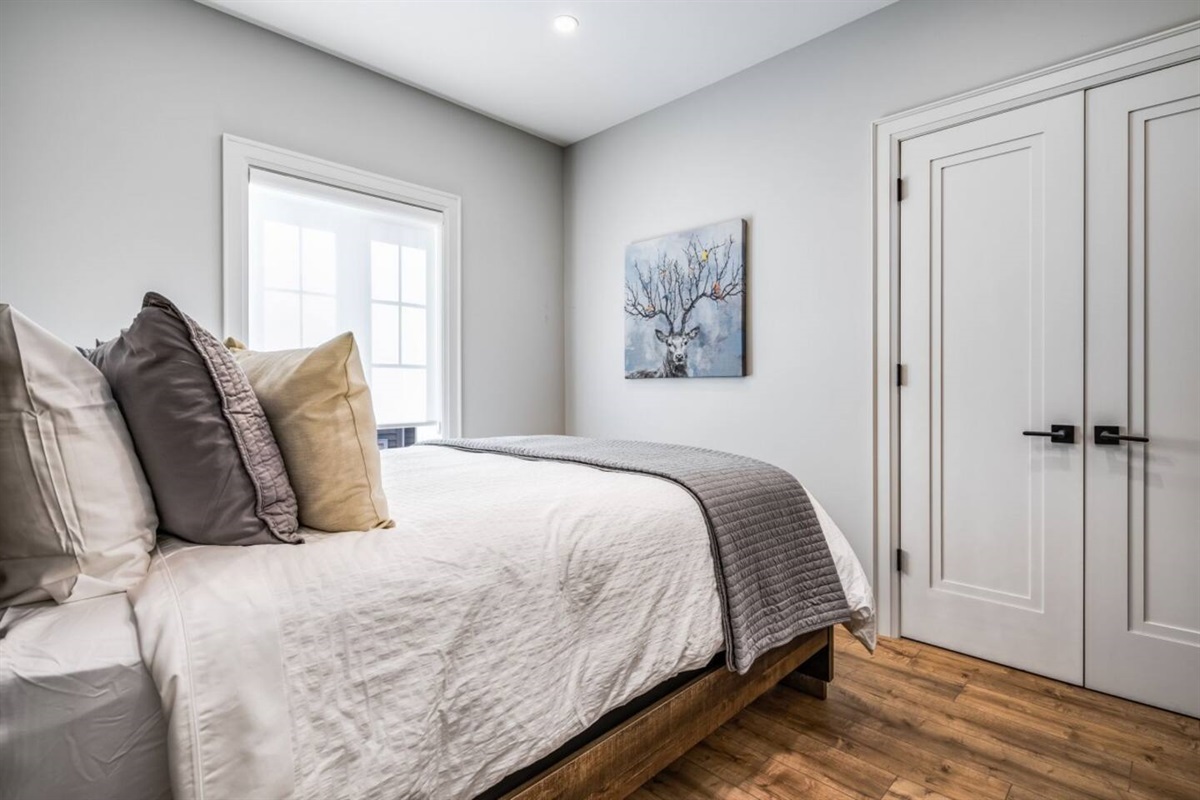 A welcoming queen bedroom offering a quiet place to retreat on the upper level.