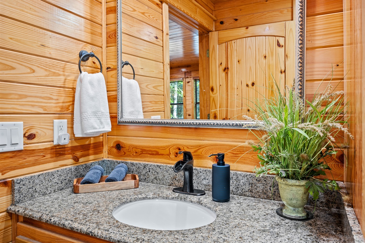 Second sink area with elegant mirror and granite counter — perfect for getting ready in the morning.
