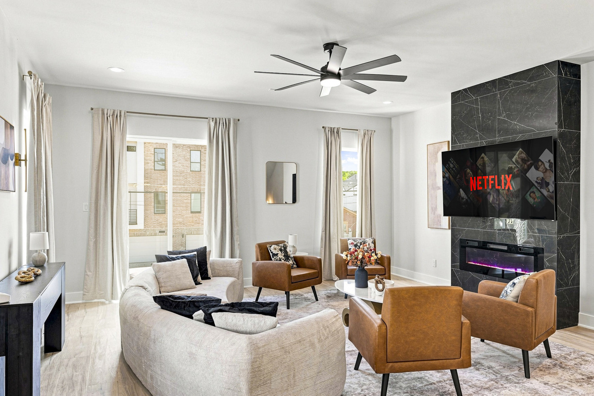 Stylish space with a sleek fireplace and ample natural light for relaxation!