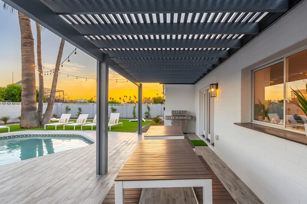 Accommodate a large group for al fresco dining at two tables with bench seating