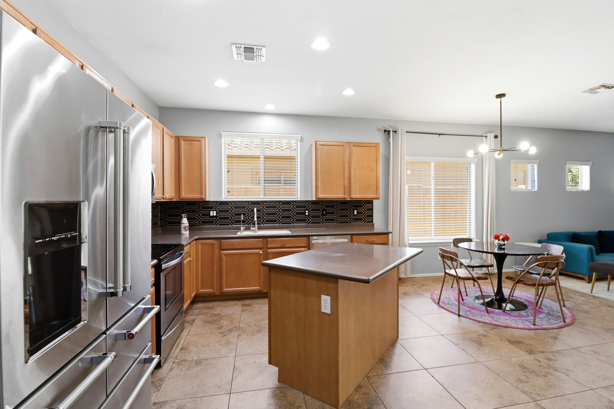Kitchen with a center island, full appliances, and the dining area just steps away.