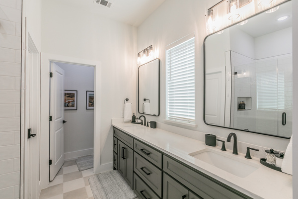 Main bathroom with double vanity and walk-in shower