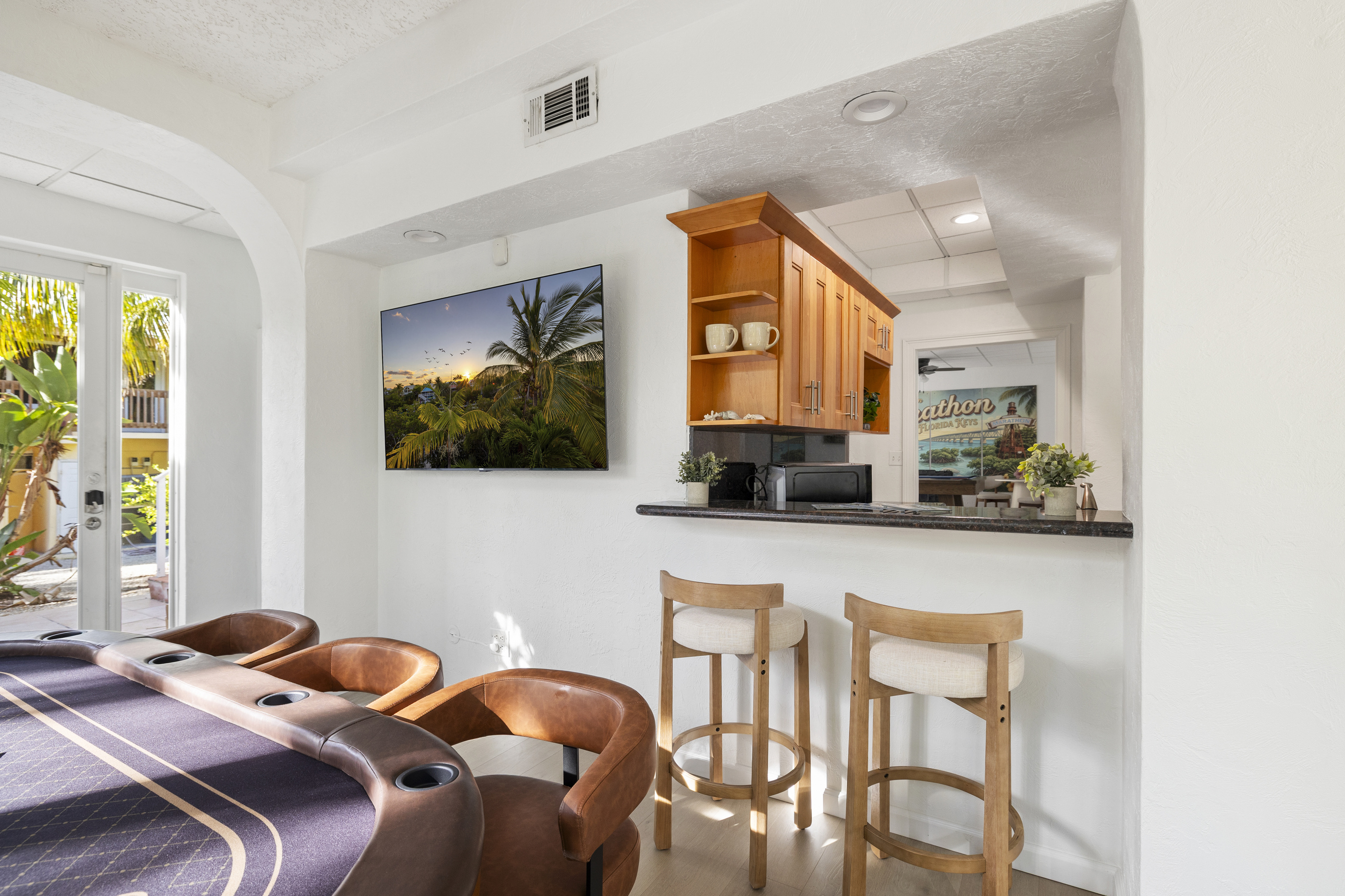 The lower level includes a kitchenete area with another refrigerator, ice machine, and sink.