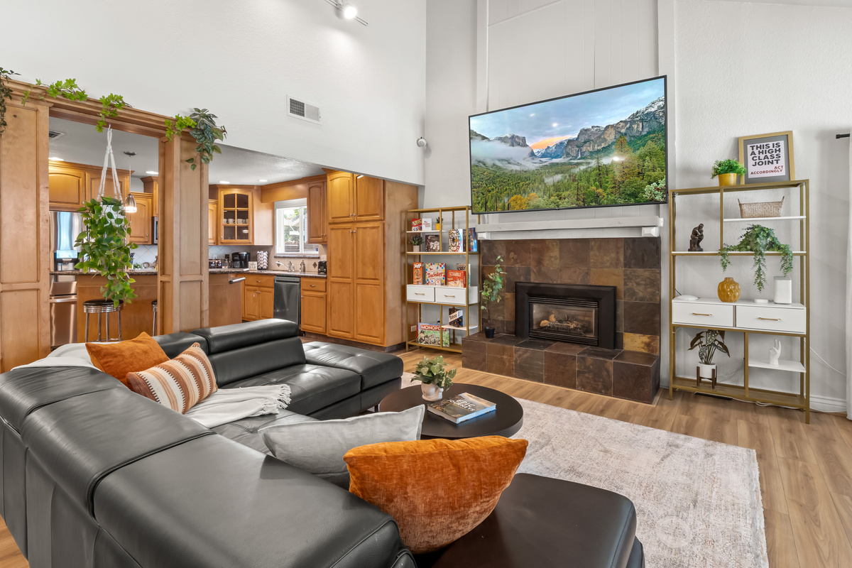 Settle into the spacious living room and enjoy a cozy night in. Comfortable sectional seating, a fireplace, and a large TV create the perfect gathering space for relaxing together.