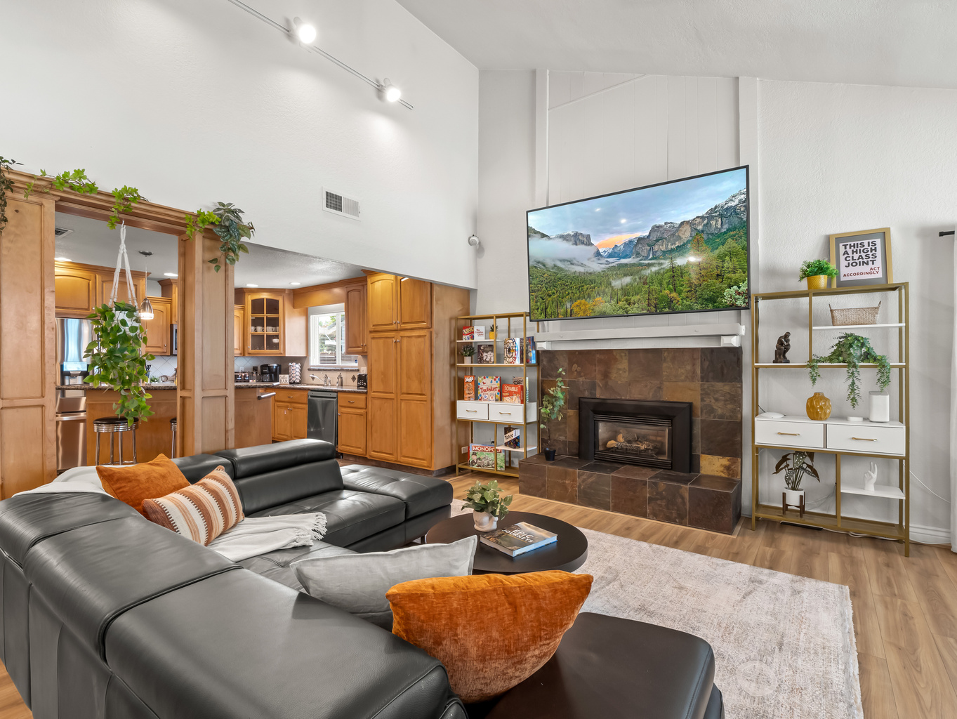 Settle into the spacious living room and enjoy a cozy night in. Comfortable sectional seating, a fireplace, and a large TV create the perfect gathering space for relaxing together.